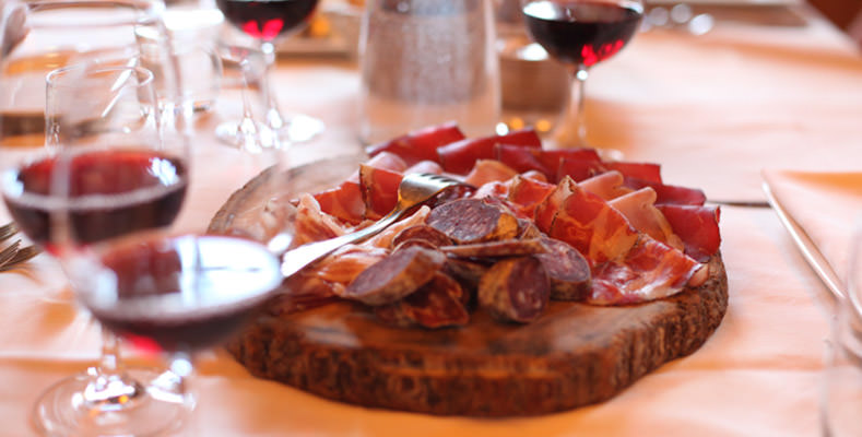 Glasses of red wine and a salumi board