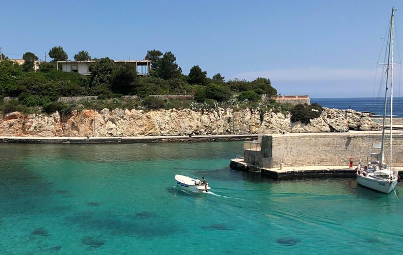 A small harbour with clear bright water in Puglia