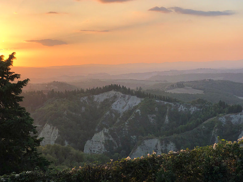 A beautiful orange sunset over the Crete Sinese in Tuscany