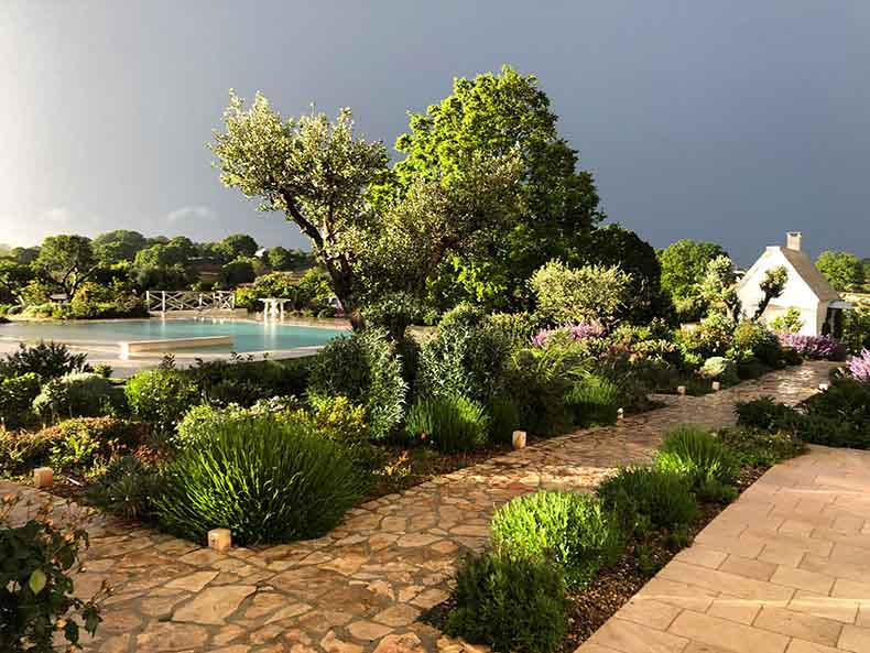 the pool and gardens of a hotel in Puglia