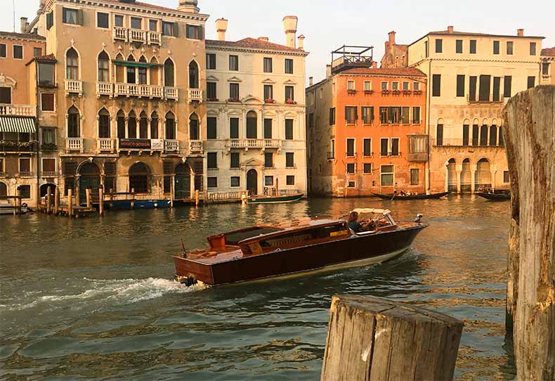 a wooden water taxi oin the main canal in Venice