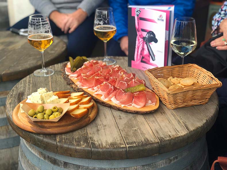 Aperitivo at the giro in the dolomites with beer, speck, olives and gerkins