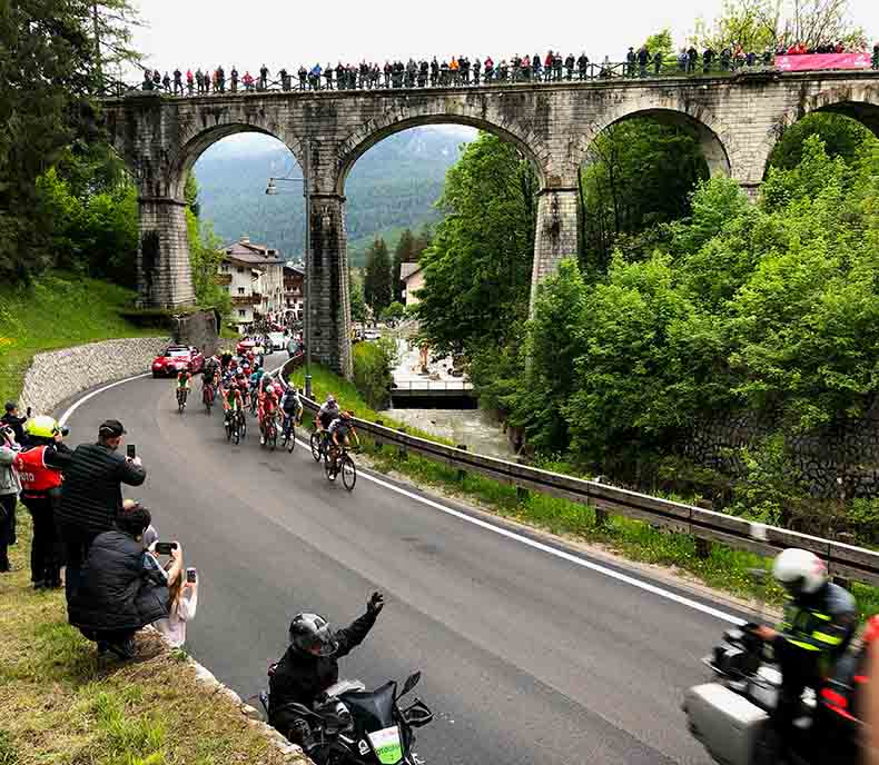 The giro d'Italia racing under a bridge in Italy