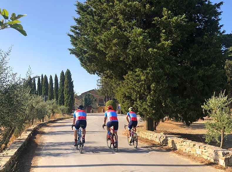 Three cyclists riding through Chianti