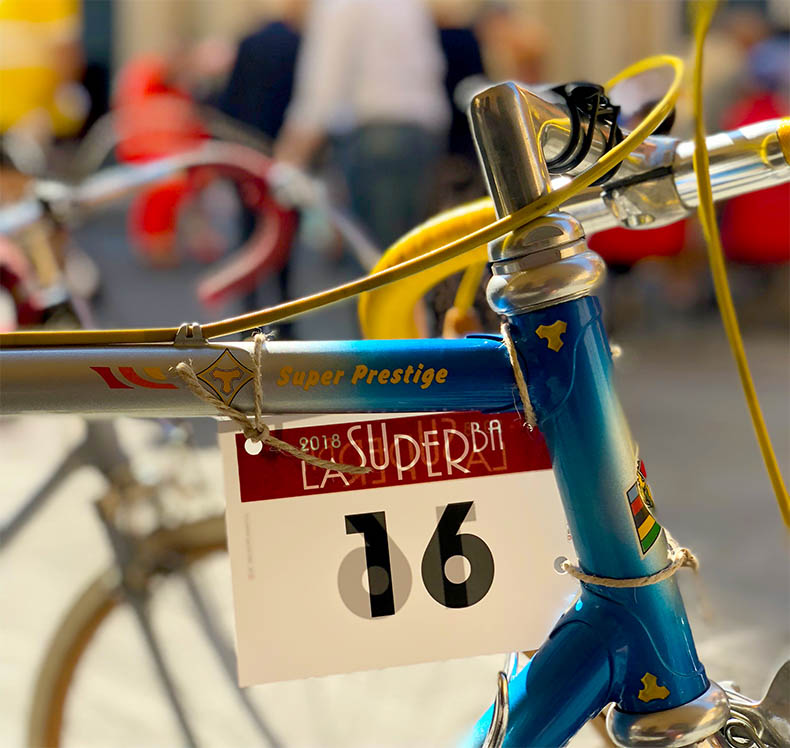 A steel vintage bicycle with a race number attached
