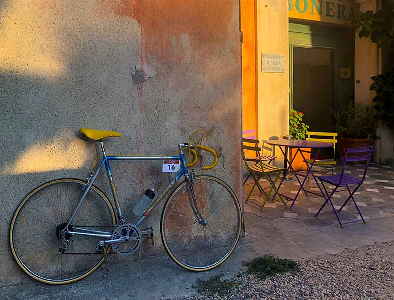 a Vintage steel bike leaning against a wall