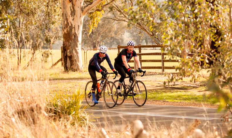 Two riders cycling in country Victoria