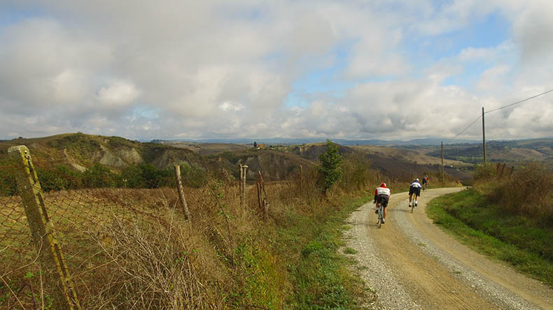 Two riders cycling on the gravel strade Bianche during L'eroica