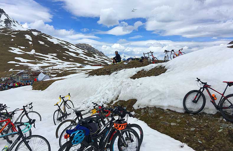 Bicycles in the snow as people wait for the Giro cycling race