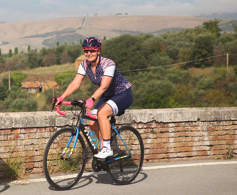 A woman riding on a cycling holiday through Tuscany