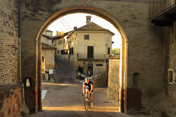 A rider cycling through a beautiful town of Piemonte