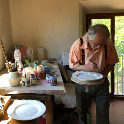 A man painting ceramics in Tuscany