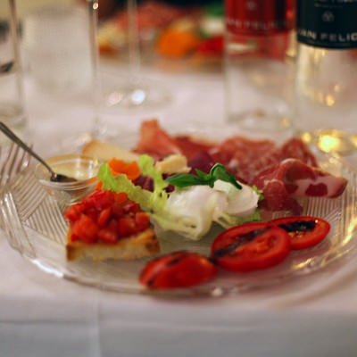 First course of salami, cheese, tomatoes and basil