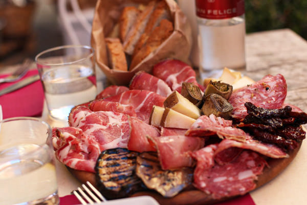 A plate of Tuscan salami, cheese and bread