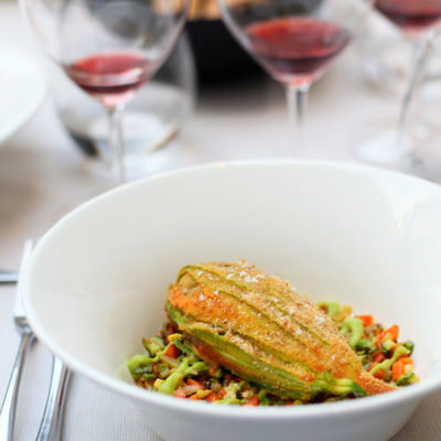 A stuffed zucchini flower and a glass of red wine in Piemonte