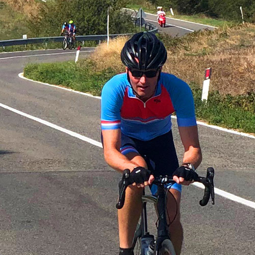 A man cycle on the windiong roads south of Siena in Italy