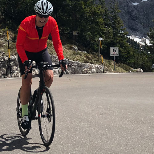 A man cycling up a mountain in the Dolomites