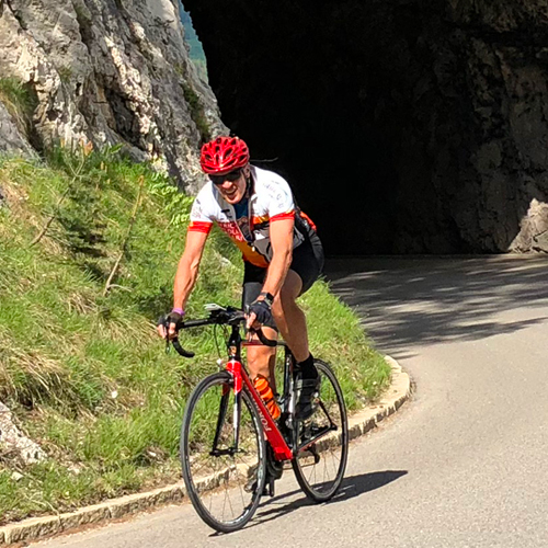 A man cycling up to Passo Falzarego
