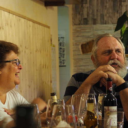 A couple taking at a dinner table in Italy