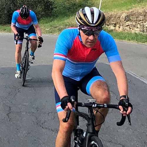 Two men cycling up a hill on a Tuscany cycling holiday