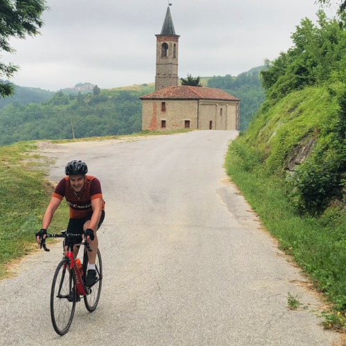 A man riding past a church in Piemonte