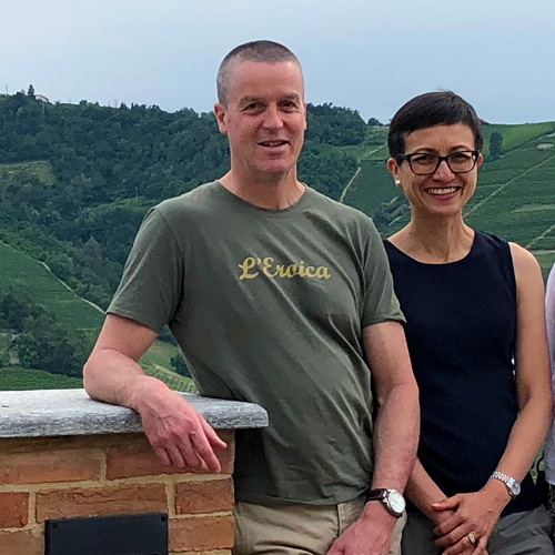 A man and woman at a wine tasting in Le Langhe