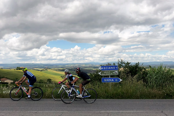 Three riders cycling in the Crete Sinese