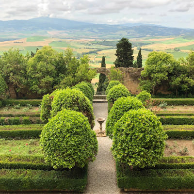 The gardens at the Piccolomini palace and the Tuscan landscape in the distance