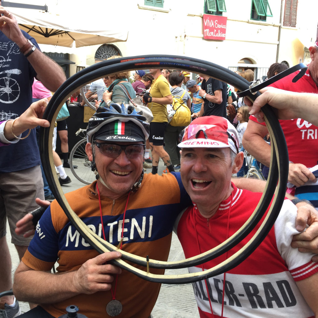 2 men celebrating in the piazza after L'eroica