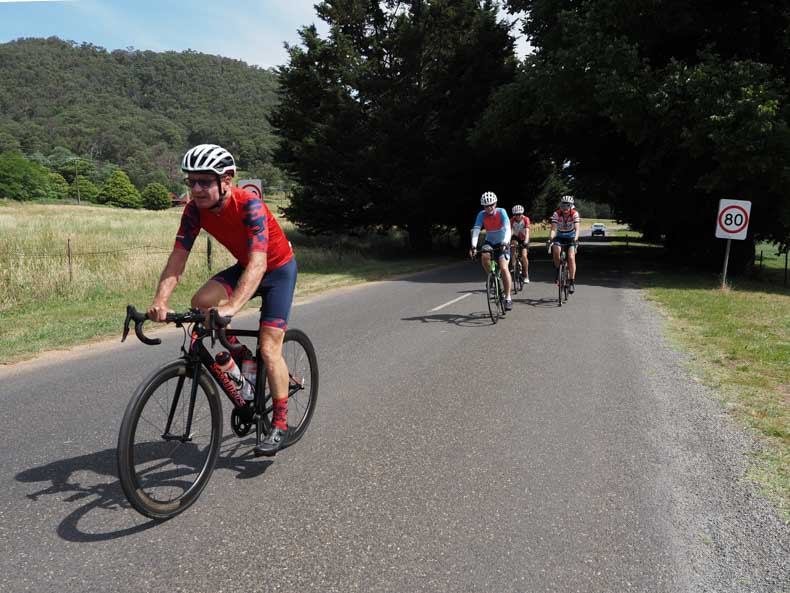 A group of cyclists riding in the bright valley