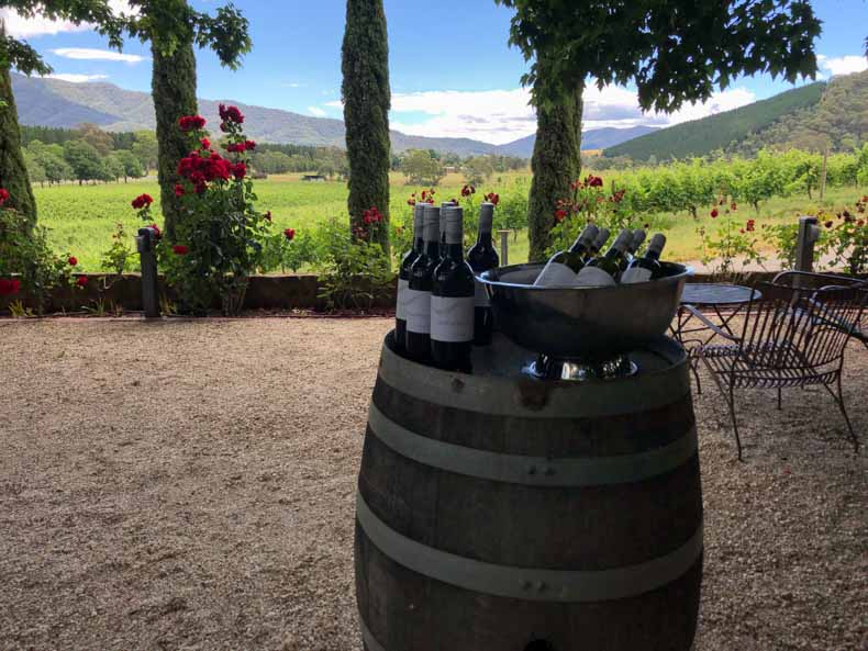 A wine barrel and bottles at a vineyard in Bright