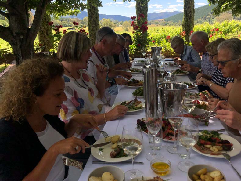 A group having lunch at a vineyard in Bright